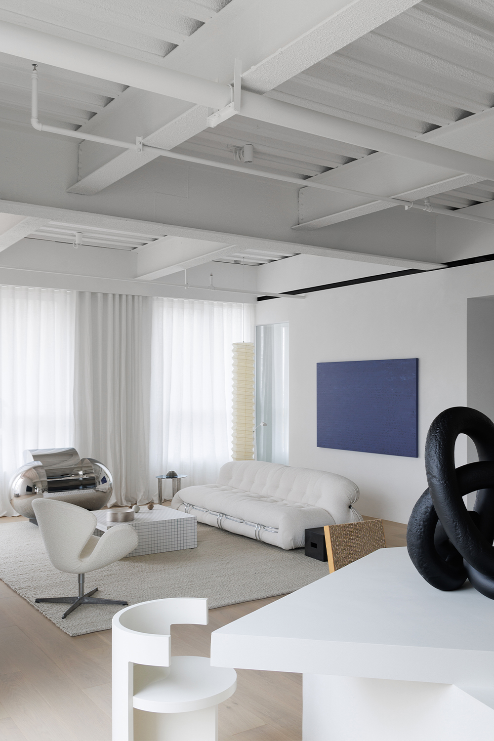 Sofa by brand Cassina-Soriana; Chair (left) by Fritz Hansen-Swan Chair ...